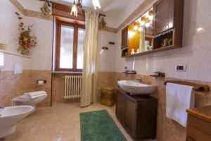 a large bathroom with two sinks and a toilet at Jasmine in Cisterna dʼAsti +15 photos