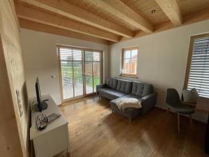 a living room with a couch and a tv at Ferienwohnung 'dahoimelig' in Friesenried