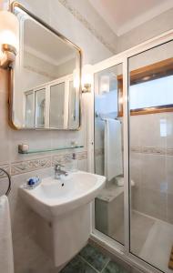 a white bathroom with a sink and a shower at Villa Vez in Arcos de Valdevez +30 photos