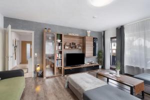 a living room with a bed and a flat screen tv at Ferienwohnung Zum Hasen in Meschede