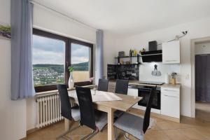 a kitchen and dining room with a table and chairs at Ferienwohnung Zum Hasen in Meschede +31 photos