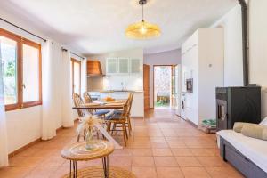 a kitchen and living room with a table and chairs at Sa Teulera Soller in Sóller