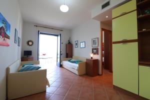 a living room with a bed and a couch at Casa Rossana a Otranto in Otranto