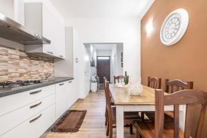 a kitchen and dining room with a table and chairs at Villetta Mattia in Pula +15 photos