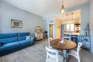 a living room with a blue couch and a table at Abaye 2 Pinot - Charm Adults Only in Soiano del Lago