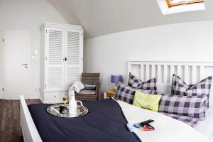 a bedroom with a bed with a tray on it at Fewo Ostseeflair by Seeblick Ferien in Kappeln