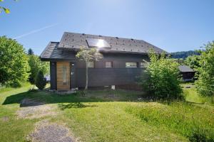 a small house with a solar panel on the roof at Ferienhaus 10 Rechbergblick in Bernau im Schwarzwald
