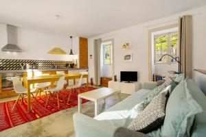 a living room with a couch and a table at Calheta Beach House T2 in Calheta