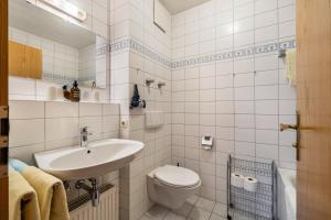 a white bathroom with a toilet and a sink at Fewo Brünnstein - Zimmer 6 in Oberaudorf +23 photos