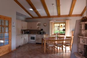 a kitchen with a table and chairs and a dining room at Haus Mövenort in Lütow