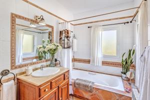 a bathroom with a tub and a sink and a mirror at Dosmadres7 in Llucmajor +27 photos