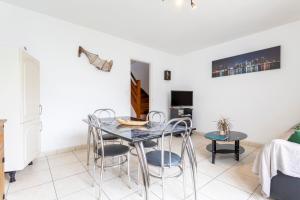 a dining room with a table and chairs at Jolie maison mitoyenne in Concarneau