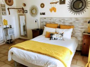 a bedroom with a large bed with a yellow blanket at La Petite Maison De Noémie in Gras +39 photos