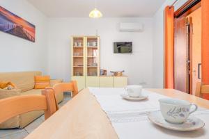a dining room with a table with two cups on it at Villetta Bifamiliare 2 in San Teodoro