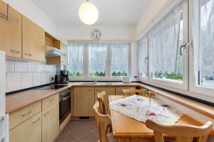 a kitchen with a table and chairs and windows at Ferienhaus Günther in Werder