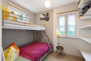 a small bedroom with a bunk bed and a window at Ferienhaus Günther in Werder