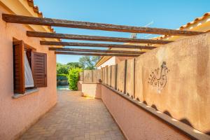 a walkway between two buildings with a wooden roof at Villetta Bifamiliare 2 in San Teodoro