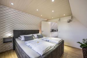 a large bed in a room with a brick wall at Ankerplatz Maria Ratekau in Ratekau +25 photos