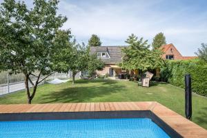 a swimming pool in the backyard of a house at Ankerplatz Maria Ratekau in Ratekau