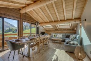 a dining room with a long table and chairs at Chalet des joux in La Clusaz
