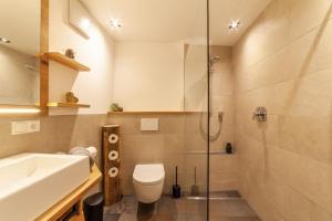 a bathroom with a sink and a toilet and a shower at Mühlanderhof Apt Piz Lad in Resia +22 photos