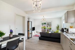 a kitchen and living room with a couch and a table at Vogtshaus in Gernsbach +15 photos