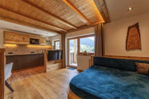a bedroom with a bed and a television in a room at Mühlanderhof Apt Piz Lad in Resia