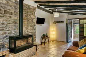 a living room with a fireplace and a couch at Can Cortada in Cantallops