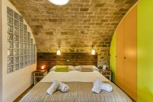 a bedroom with a bed in a brick wall at Can Cortada in Cantallops