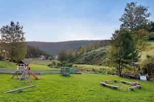 a park with a playground with a slide and a swing set at Haus Löwen in Forbach +38 photos