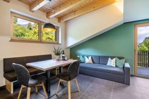 a dining room with a couch and a table and chairs at Wiesgut Ferienwohnung Gala in Tesimo