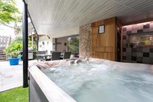 a hot tub in the backyard of a house at Gîte Les Galets Blancs in Trébeurden