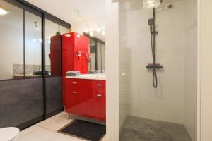 a bathroom with a red cabinet and a sink at Gîte Les Galets Blancs in Trébeurden +21 photos