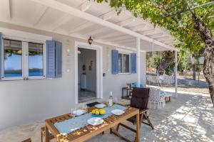 a patio with a table with fruit on it at Elia Perigiali Lefkada in Nydri