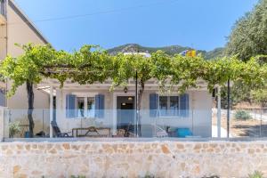 a house with a bunch of grapes on a wall at Elia Perigiali Lefkada in Nydri