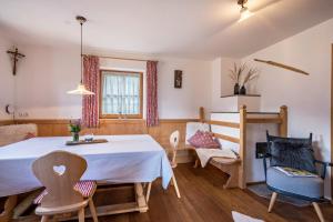 a room with a table and chairs in a room at Thaler-hof Ferienhaus Fichtnhittl in Lagundo +25 photos