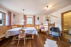 a dining room with a table and chairs at Thaler-hof Ferienhaus Fichtnhittl in Lagundo