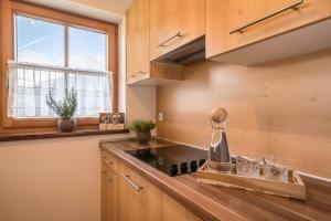 a kitchen with a stove and a window at Thaler-hof Ferienhaus Fichtnhittl in Lagundo