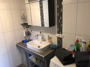 a bathroom with a sink and a mirror at Ferienwohnung Wiesenblick in Plettenberg +10 photos