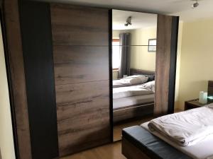 a sliding door in a bedroom with two beds at Ferienwohnung Wiesenblick in Plettenberg