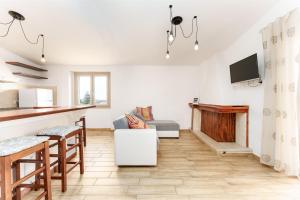 a kitchen and living room with a fireplace at Cozy And Cool Flat in Orosei