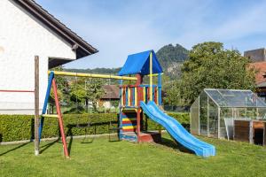 a playground with a slide in a yard at Ferienwohnung Hewenpanorama 1 in Engen