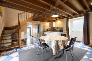a kitchen and dining room with a table and chairs at Gîte La Malcotais in Noyal-Châtillon-sur-Seich +12 photos