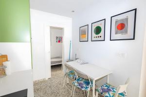 a white room with a desk and two chairs at Casa de Arte in Torrox +11 photos