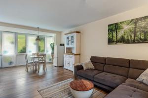 a living room with a couch and a table at Hof Helmenhube 1 in Oberzent