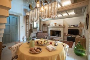 a dining room with a table with food on it at La dimora Elia' in Muro Leccese