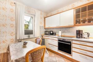 a kitchen with a table and a table and chairs at Ferienwohnung Ruhrtal in Bestwig