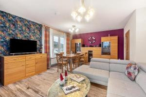 a living room with a couch and a tv at Ferienwohnung Ruhrtal in Bestwig