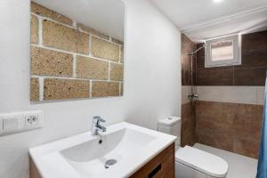 a bathroom with a sink and a toilet at Finca Eva in Granadilla de Abona +16 photos