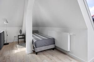 a bedroom with a bed in a white room at Ferienwohnung 2 in Bad Salzuflen